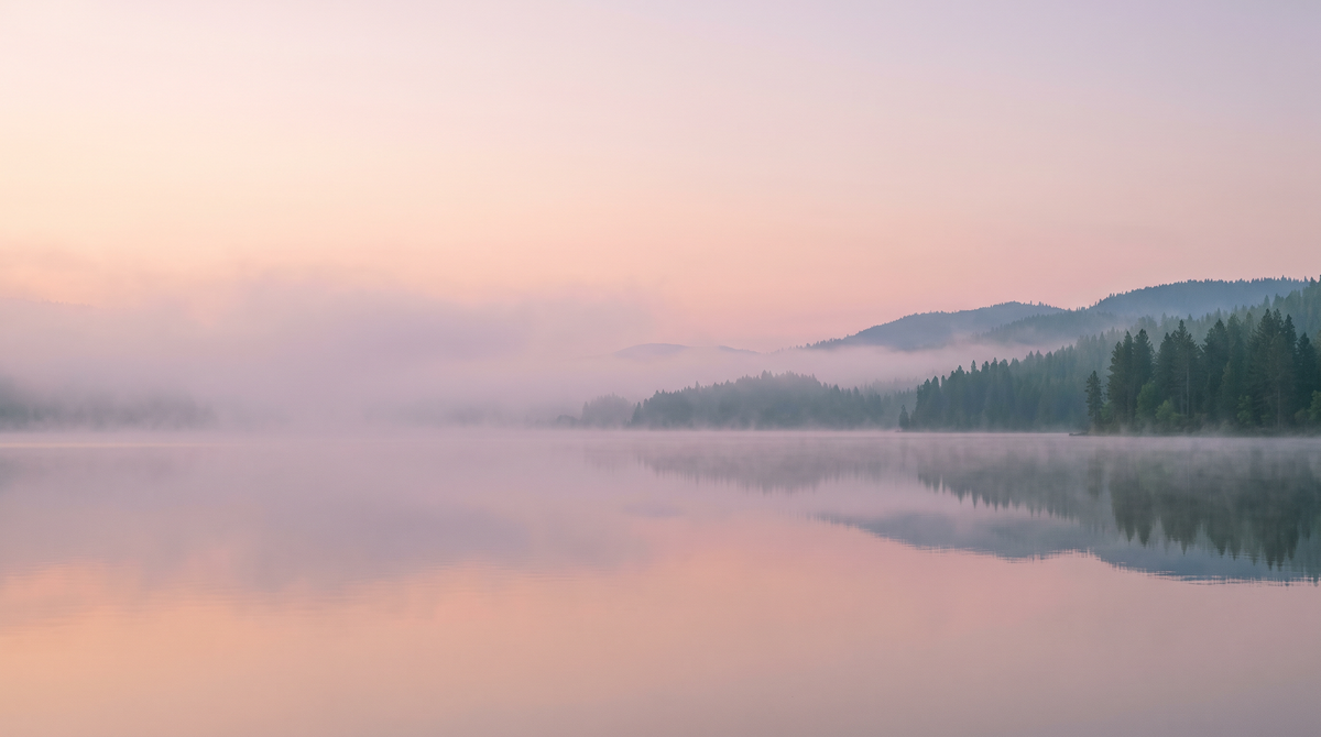 Still misty lake at dawn